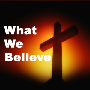 Image of a cross with the text "What We Believe"